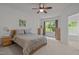 Bright bedroom with a ceiling fan, a comfortable bed, and natural light from the window at 740 Treviso Ln, Apex, NC 27502