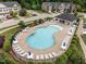 Aerial view of the community pool area, complete with lounge chairs and umbrellas at 740 Treviso Ln, Apex, NC 27502
