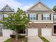 Charming townhome with brick accents, attached garages, and mature landscaping at 740 Treviso Ln, Apex, NC 27502