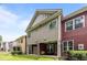 Townhome back exterior featuring a covered patio and colorful siding at 740 Treviso Ln, Apex, NC 27502