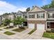 Townhome with a brick front, garage, and well-manicured landscaping at 740 Treviso Ln, Apex, NC 27502