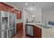 Well-equipped kitchen featuring stainless steel appliances and wooden cabinets at 740 Treviso Ln, Apex, NC 27502