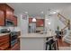 Kitchen with granite counters, stainless appliances, and wood cabinets at 740 Treviso Ln, Apex, NC 27502