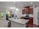Kitchen with granite counters, island seating, and stainless steel appliances at 740 Treviso Ln, Apex, NC 27502