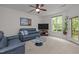 Comfortable living room with a ceiling fan, flat-screen TV, sofas, and natural light from a window at 740 Treviso Ln, Apex, NC 27502