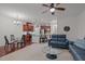 Open-concept living room with a kitchen and living room area with ceiling fan and recessed lighting at 740 Treviso Ln, Apex, NC 27502
