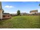 Large fenced backyard with a lush green lawn and a wooden deck at 76 Haywood St, Spring Lake, NC 28390