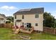 Spacious backyard with a wooden deck, fenced-in yard, and solar panels on roof at 76 Haywood St, Spring Lake, NC 28390