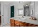 Bathroom with wooden vanity and decorative stained-glass window at 76 Haywood St, Spring Lake, NC 28390