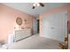 Comfortable bedroom with a dresser, closet, ceiling fan, and soft carpet at 76 Haywood St, Spring Lake, NC 28390