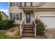 Home's entrance boasts brick stairs, fresh landscaping, and a classic front door at 76 Haywood St, Spring Lake, NC 28390