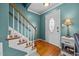 Inviting entryway featuring a staircase, front door, and side table with lamp at 76 Haywood St, Spring Lake, NC 28390