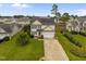 Aerial view of a well-maintained home with a landscaped front yard and solar panels at 76 Haywood St, Spring Lake, NC 28390
