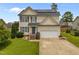 Charming two-story home featuring solar panels, a well-maintained lawn, and a two-car garage at 76 Haywood St, Spring Lake, NC 28390