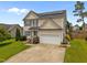 Charming two-story home featuring solar panels, a well-maintained lawn, and a two-car garage at 76 Haywood St, Spring Lake, NC 28390