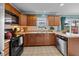Kitchen with wood cabinets, black appliances, and a view of the backyard at 76 Haywood St, Spring Lake, NC 28390