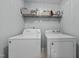 A laundry room with a washer, dryer, and shelving at 76 Haywood St, Spring Lake, NC 28390