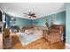Inviting living room with a comfortable sectional sofa, ceiling fan, and decor at 76 Haywood St, Spring Lake, NC 28390