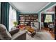 This cozy living room features built-in bookshelves, comfortable seating, and a view to the dining room at 76 Haywood St, Spring Lake, NC 28390