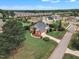 Spacious brick home with an attached garage nestled in a residential neighborhood with lush green lawns and trees at 7800 Twin Pines Way, Fuquay Varina, NC 27526