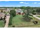 Well-maintained brick home with attached garage, surrounded by green lawns and mature trees in a quiet neighborhood at 7800 Twin Pines Way, Fuquay Varina, NC 27526