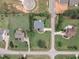 Aerial view showcasing a home's positioning within a residential area, surrounded by mature trees and green lawns at 7800 Twin Pines Way, Fuquay Varina, NC 27526