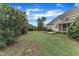 Large backyard with mature trees, lush green grass, and a patio area perfect for outdoor entertaining at 7800 Twin Pines Way, Fuquay Varina, NC 27526