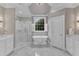 Bright bathroom featuring marble floors, a soaking tub, and a glass shower at 7800 Twin Pines Way, Fuquay Varina, NC 27526