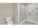Bathroom features a toilet and a shower with a patterned curtain at 7800 Twin Pines Way, Fuquay Varina, NC 27526