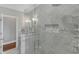 Beautiful marble shower featuring modern fixtures, and frameless glass at 7800 Twin Pines Way, Fuquay Varina, NC 27526