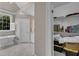 Bright bathroom with walk-in shower, soaking tub, and walk-in closet at 7800 Twin Pines Way, Fuquay Varina, NC 27526