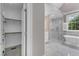 Bright bathroom with a walk-in shower, soaking tub, and view to backyard at 7800 Twin Pines Way, Fuquay Varina, NC 27526