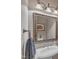 Stylish bathroom features a vessel sink with a large framed mirror and elegant lighting at 7800 Twin Pines Way, Fuquay Varina, NC 27526