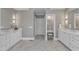 Elegant bathroom featuring double vanities, marble countertops, and a well-lit makeup area at 7800 Twin Pines Way, Fuquay Varina, NC 27526