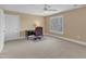 Neutral bedroom with window, ceiling fan and desk, creating a peaceful atmosphere at 7800 Twin Pines Way, Fuquay Varina, NC 27526