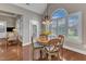 Sunny breakfast nook with round table, chairs, and a large arched window at 7800 Twin Pines Way, Fuquay Varina, NC 27526