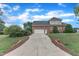 Charming brick home featuring a well-maintained driveway, a two-car garage, and inviting curb appeal at 7800 Twin Pines Way, Fuquay Varina, NC 27526