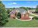 Attractive two-story brick home with a landscaped front yard, elegant entrance, and welcoming curb appeal at 7800 Twin Pines Way, Fuquay Varina, NC 27526