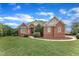 Charming brick home with landscaped yard and inviting front entrance with a blue sky backdrop at 7800 Twin Pines Way, Fuquay Varina, NC 27526