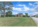 Brick home on a verdant lot with mature trees, blending suburban charm with natural beauty at 7800 Twin Pines Way, Fuquay Varina, NC 27526