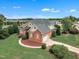 Lovely two-story brick home featuring an attached garage, well-kept lawn, and charming architectural details at 7800 Twin Pines Way, Fuquay Varina, NC 27526