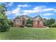 Stately brick residence, perfectly manicured lawn, and welcoming entrance, all under a bright sky at 7800 Twin Pines Way, Fuquay Varina, NC 27526
