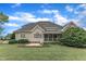 Rear exterior view highlighting the well-manicured lawn and architectural details of the home at 7800 Twin Pines Way, Fuquay Varina, NC 27526
