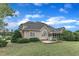 Back of home featuring well-maintained yard, mature trees, and screened in porch at 7800 Twin Pines Way, Fuquay Varina, NC 27526