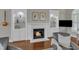 Close-up of a cozy fireplace with white mantel, built-in shelves, and a mounted TV at 7800 Twin Pines Way, Fuquay Varina, NC 27526