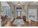 Elegant foyer with hardwood floors, high ceilings, grand chandelier, and an arched doorway at 7800 Twin Pines Way, Fuquay Varina, NC 27526