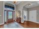 Spacious foyer featuring hardwood floors, a decorative rug, and a grand entrance with abundant natural light at 7800 Twin Pines Way, Fuquay Varina, NC 27526