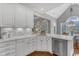 Kitchen area with white cabinets, stainless steel dishwasher, and marble countertops at 7800 Twin Pines Way, Fuquay Varina, NC 27526