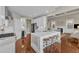Spacious kitchen with white cabinets, a marble island, and stainless steel appliances at 7800 Twin Pines Way, Fuquay Varina, NC 27526