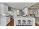 Well-lit kitchen with white cabinets, marble countertops, and a central island with seating at 7800 Twin Pines Way, Fuquay Varina, NC 27526